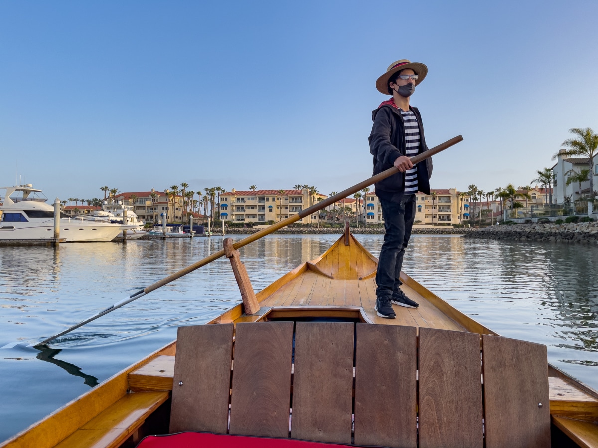 Beautiful Oxnard gondolier at the helm of gondola in Channel Islands Harbor
