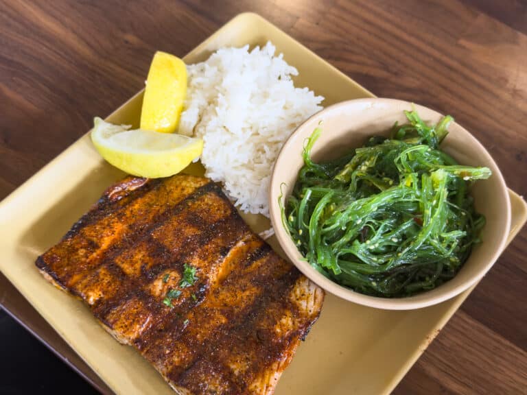 Salmon with Fish Shop Rub, seaweed salad, and jasmine rice.