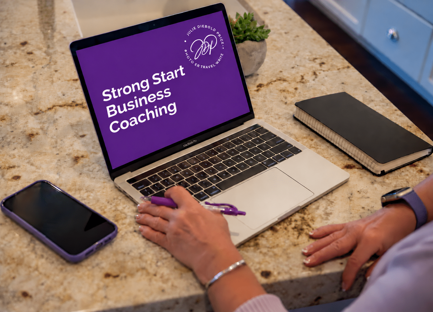 A laptop with Stron Start Business coaching on the screen.